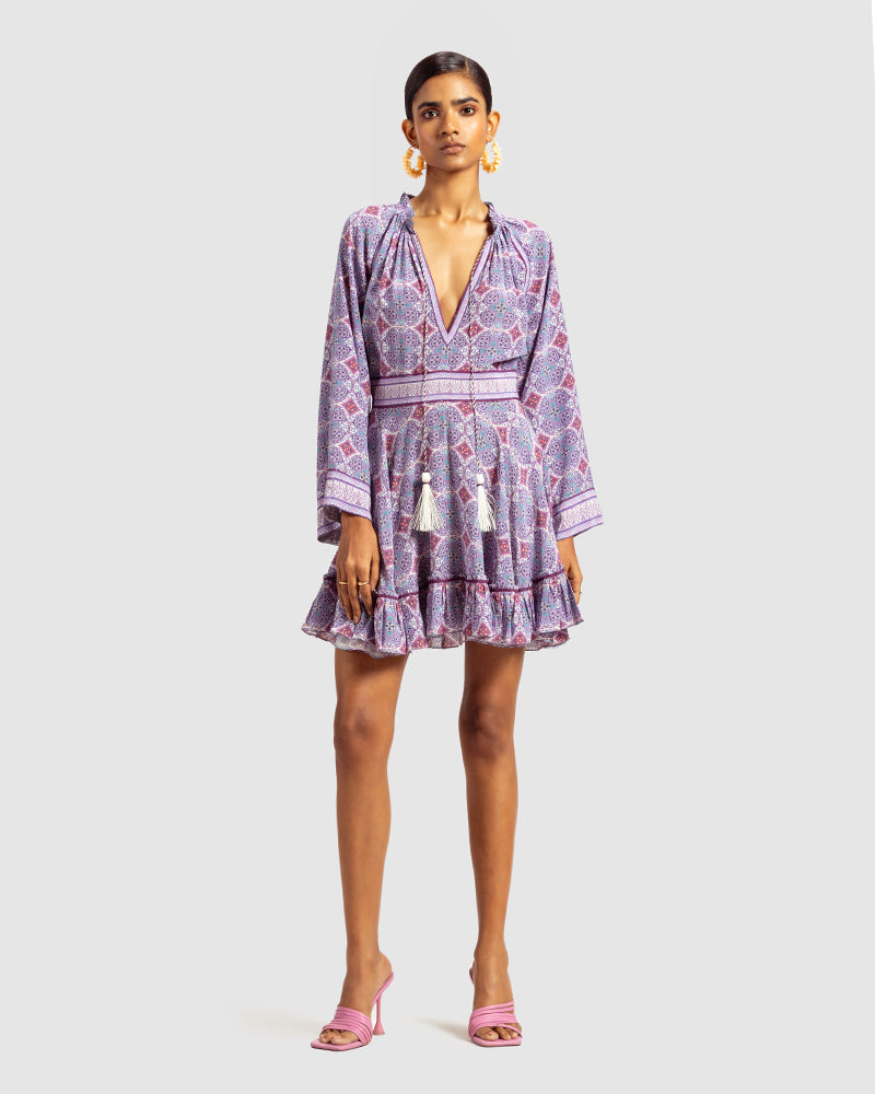 Lavender Marissa Print Ruffled Silk DressProduct DescriptionThis print patchwork ruffled dress is a mix of fit and flare, making it a perfect summer dress. It features a V-shaped neckline, a tasselled drawsDressesLavender Marissa Print Ruffled Silk Dress