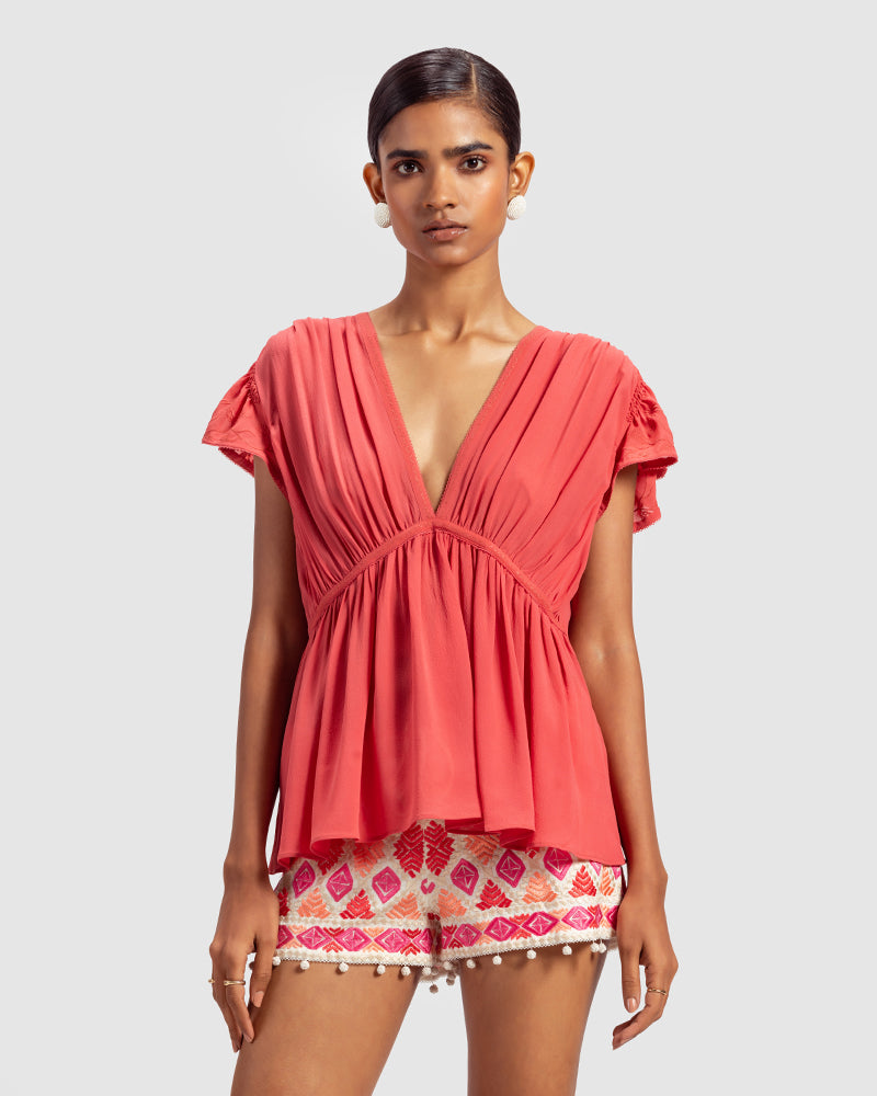 Coral Gathered Silk Georgette TopProduct DescriptionMade from 100% silk georgette, this top features hand-guided machine embroidery inspired by floral motifs. Details include a V-shaped neckline, smTopsCoral Gathered Silk Georgette Top