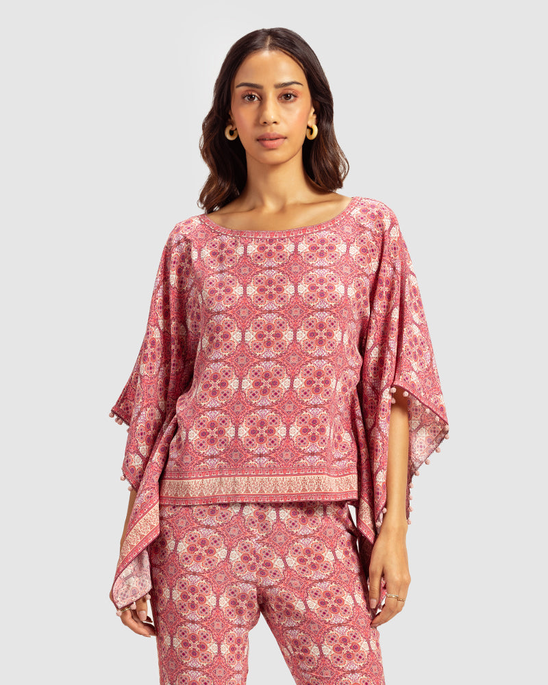 Pink Marissa Print Silk Poncho TopProduct DescriptionMade from silk crepe, this boatneck poncho top features our modern geometric print patchwork. Comes in a relaxed fit and also features bobble trimTopsPink Marissa Print Silk Poncho Top