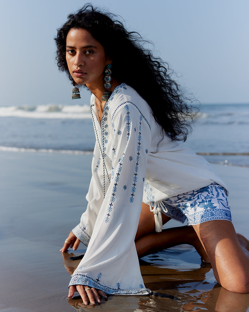 Blue on White Embroidered Satin Blend TopProduct DescriptionThis relaxed-fit top is adorned with Kolam-inspired motif embroidery, and also features tassels on the front-neck drawstring and sleeve hems. 
FroWhite Embroidered Satin Blend Top